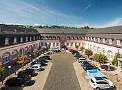 Außenansicht des Schlosshotel Weilburg mit großem Parkplatz