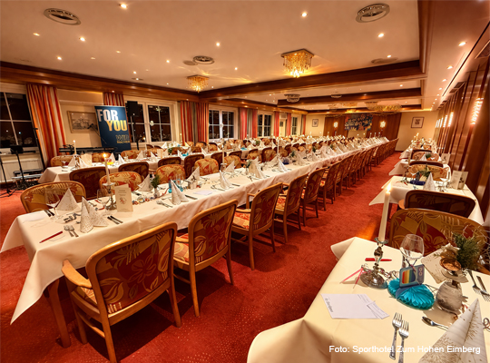 Speisesaal mit langer, festlich gedeckter Tafel