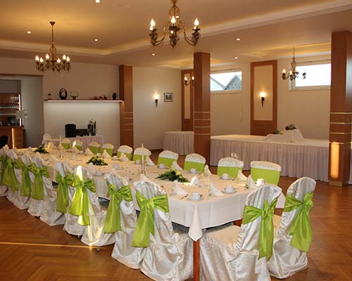 Festlich eingerichteter Speisesaal, mit wünderschönen Stuhl-Hussen und prachtvollen Kronleuchtern.