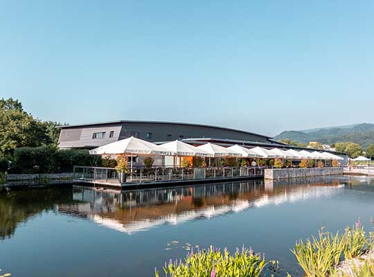 Außenansicht mit Blick übers Wasser auf das moderne Restaurant Delcato