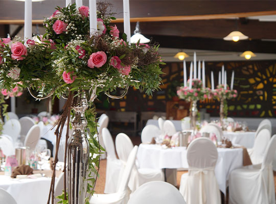 Schöner Strauß mit rosa Rosen auf weißen Banketttischen beim Krimidinner Hamburg