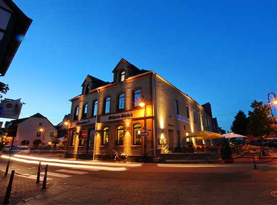 Beleuchtetes Brauhaus bei Abenddämmerung, dunkelblauer Himmel mit majestätischem Brauhaus