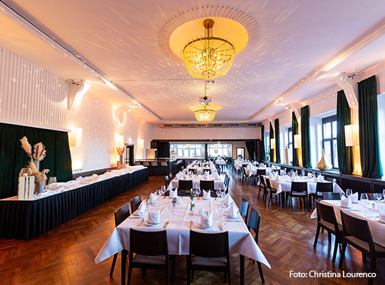 Viele festlich gedeckte Tische in großem Saal für das Krimidinner im Bootshaus Mannheim