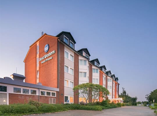 Außenansicht auf das große sowie moderne Hotelgebäude bei strahlend blauem Himmel.